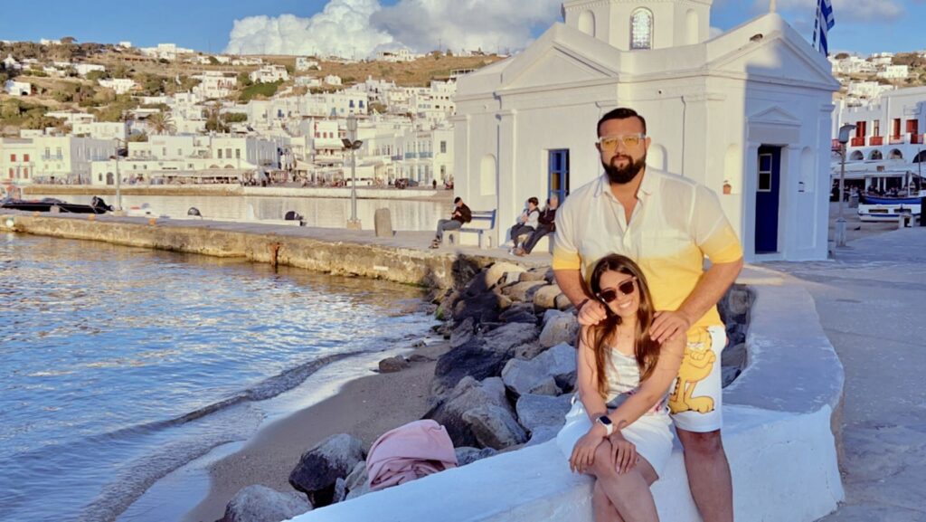 A couple in front of a church in mykonos town