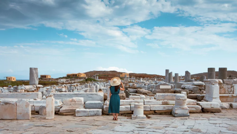 Tourist on Delos island staring at the ruins