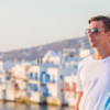 Couple standing with Mykonos Little Venice in the background.